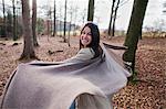 Older woman cheering in forest