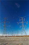 Power lines against blue sky