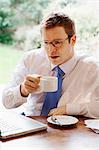 Businessman using laptop at breakfast