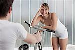 Woman laughing on exercise machine