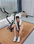 Man talking on cell phone in home gym
