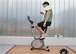 Man using cell phone on exercise machine