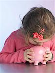 Girl kissing piggy bank