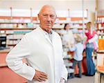 Smiling pharmacist standing in store