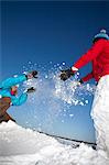 Couple playing with snow in field