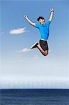 Man jumping for joy over wind turbines