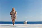 Woman meditating on tiled surface