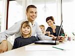 Father and daughter using laptop