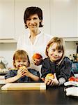 Mother and daughters eating in kitchen