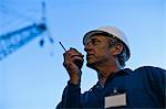 Worker using walkie talkie on site