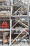 Workers talking at oil refinery