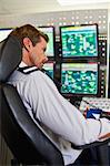 Man working in security control room