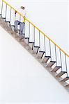 Worker climbing steps at chemical plant