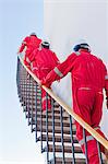 Workers on steps at chemical plant