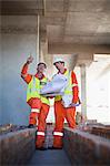 Workers reading blueprints on site