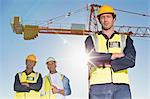 Workers standing at construction site