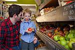 Father and son buying produce in store