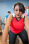 Woman using spin machine in gym