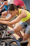 Woman using spin machine in gym