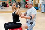 Woman working with trainer in gym