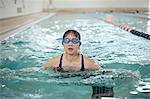 Woman doing laps in swimming pool