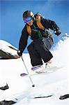 Skier jumping off snowy slope