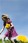 Girl picking wildflowers in field