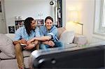 Men watching television in living room