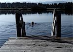 Man swimming in still lake