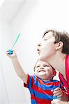 Mother and son blowing bubbles together