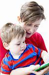 Mother and son reading book together