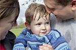 Couple hugging toddler son