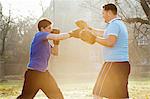 Boxer training with coach outdoors