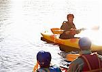 Teacher talking to students in kayaks