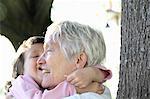 Woman holding granddaughter outdoors