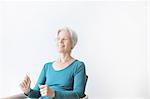 Smiling older woman sitting in chair