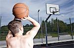 Man playing basketball on urban court