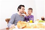 Father and son eating breakfast