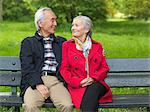 Older couple sitting on park bench