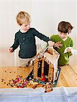 Boys decorating gingerbread house