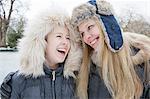 Mother and daughter laughing in snow