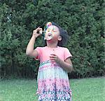 Girl blowing bubbles outdoors