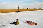 Children in skates laying on ice