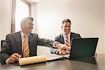 Two male business lawyers chatting in office