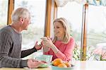 Mature couple chatting about text message on smartphone