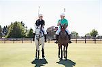Two adult men playing polo