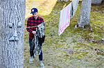 High angle view of mid adult man hanging out laundry in garden