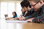 Students writing in classroom