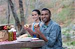 Portrait of father and daughter eating burgers whilst camping, Sedona, Arizona, USA