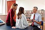 Doctor talking to patient and mother